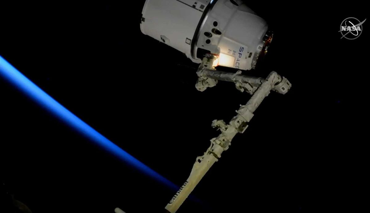 The last SpaceX Dragon to be captured by a robotic arm on the International Space Station is seen just after capture on March 9, 2020. All future Dragons will be able to dock themselves at the station.