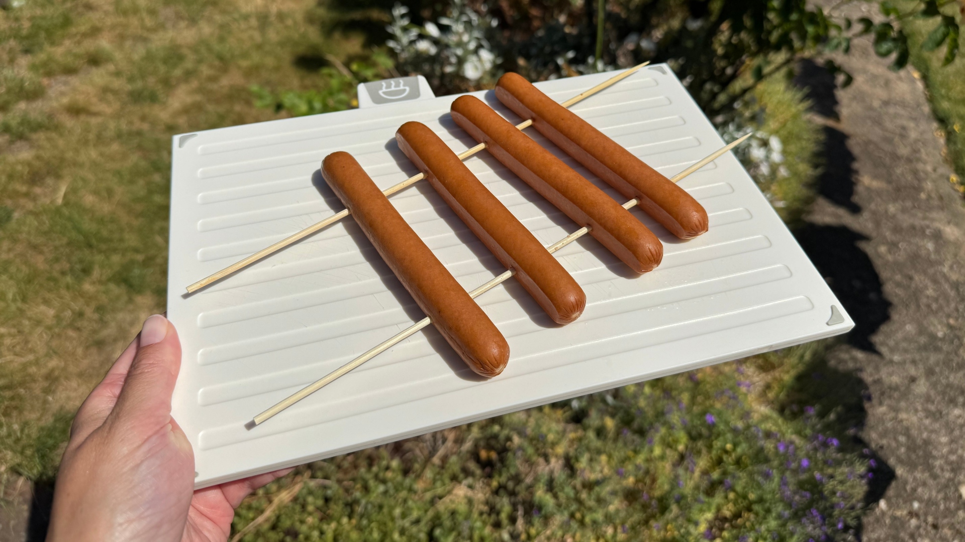 Hot dogs and skewers on a cutting board