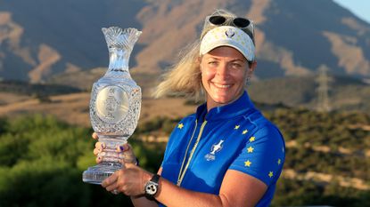 Team Europe captain Suzann Pettersen holding up the Solheim Cup trophy after their victory in 2023