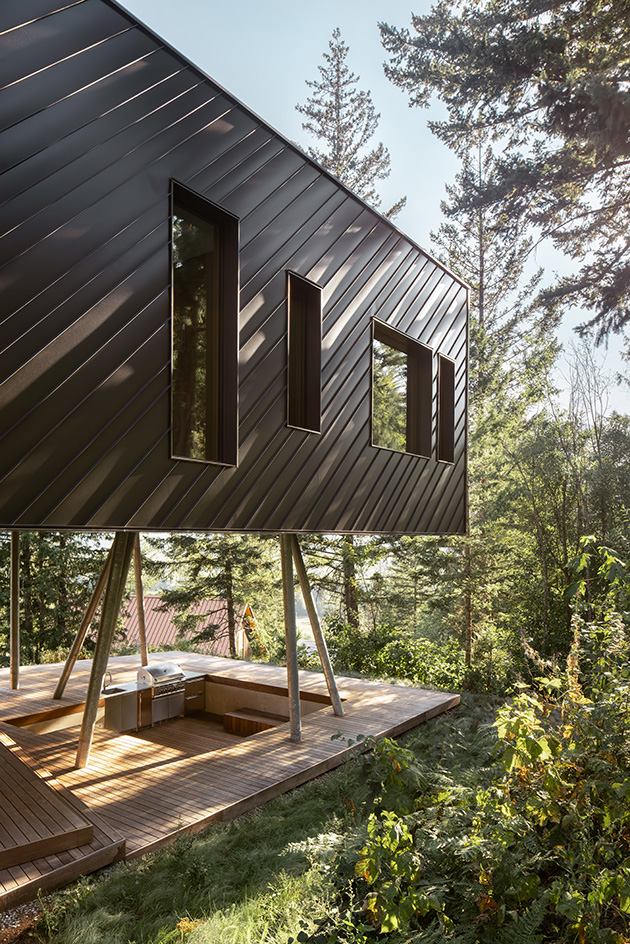 view of Passive House Forest Retreat, a timber structure engulfed in the tree canopy