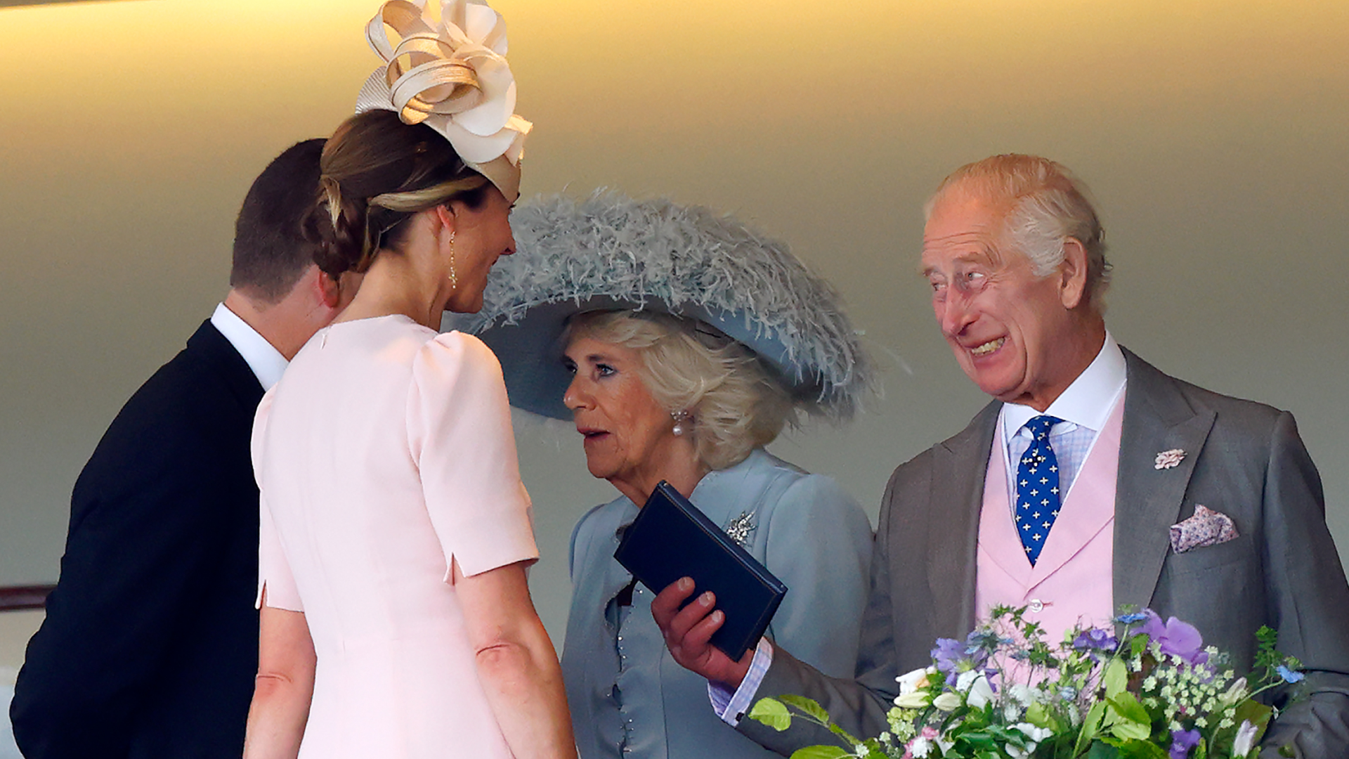 King Charles smiling next to Queen Camilla, talking to Harriet Sperling and Peter Phillips at Royal Ascot 