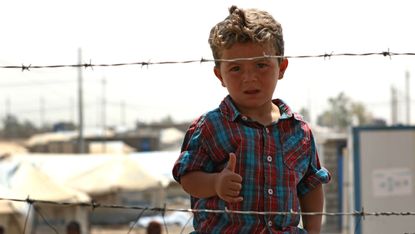 A displaced Iraqi boy at the Debaga camp, east of Makhmur in northern Iraq, in August