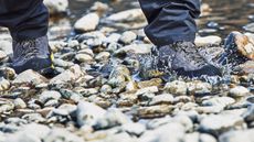 Man wearing Scarpa Mescalito approach shoes in a shallow stream