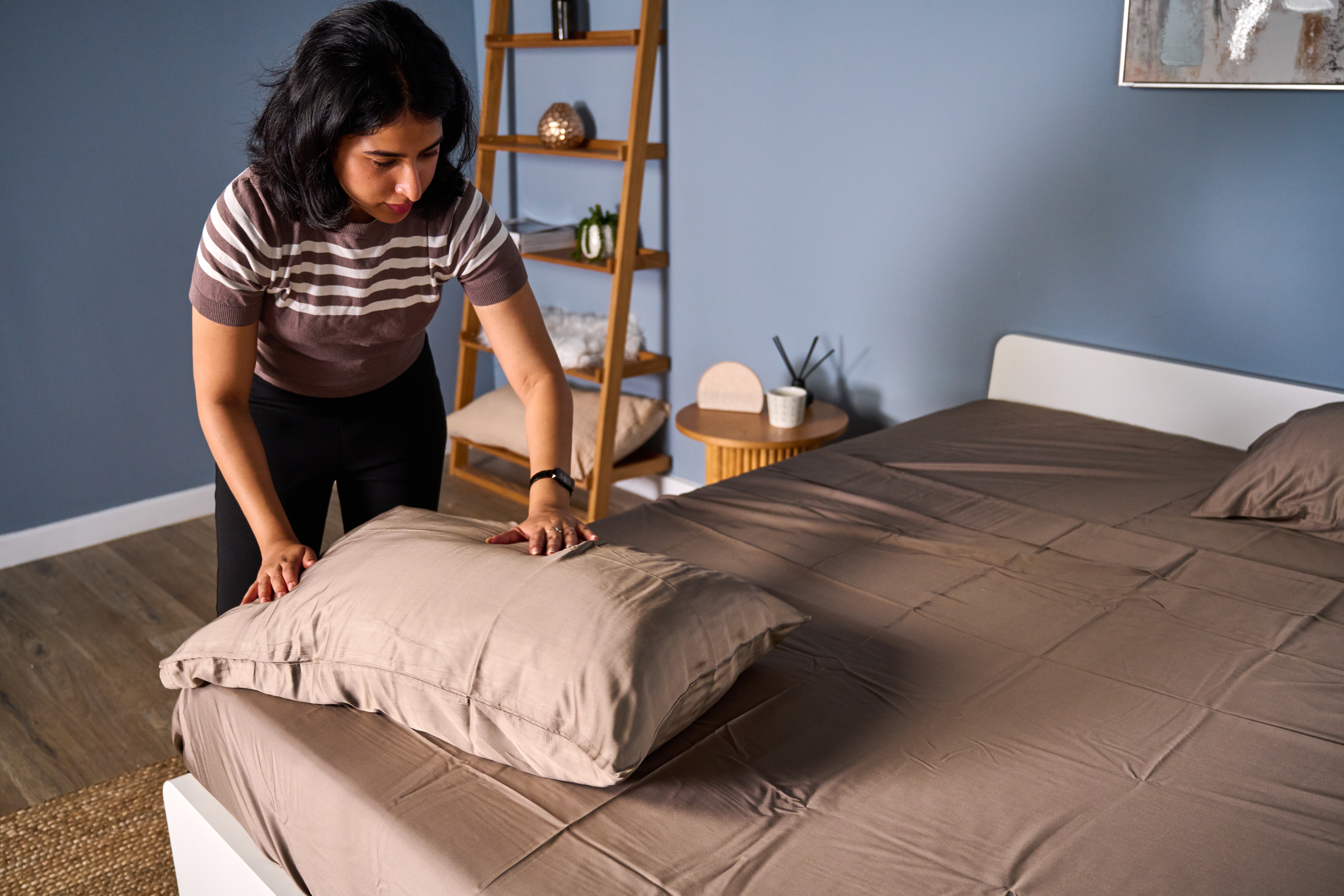 Checking the temperature regulation by placing hand on the fabric of the Cozy Earth bamboo sheet set