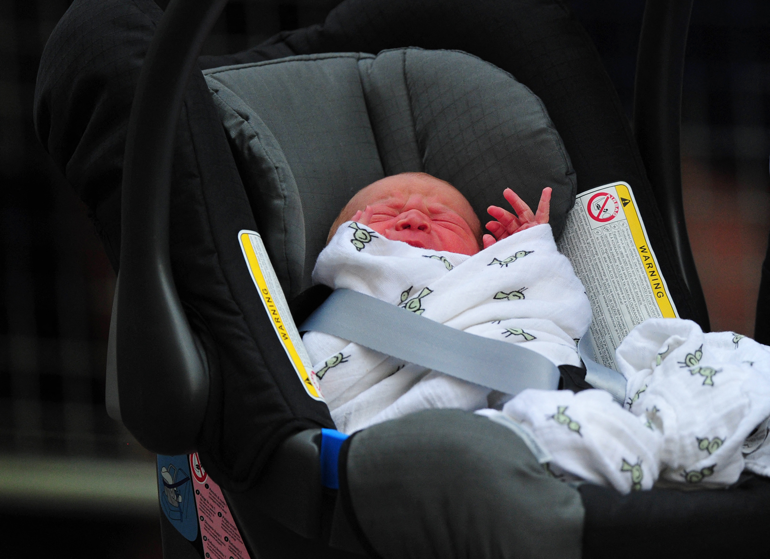 Prince William and Catherine, Duchess of Cambridge's new-born baby boy seen in a car seat outside the Lindo Wing