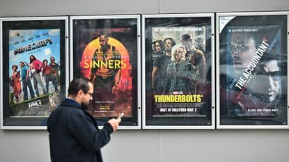 Man considers movies at cinema