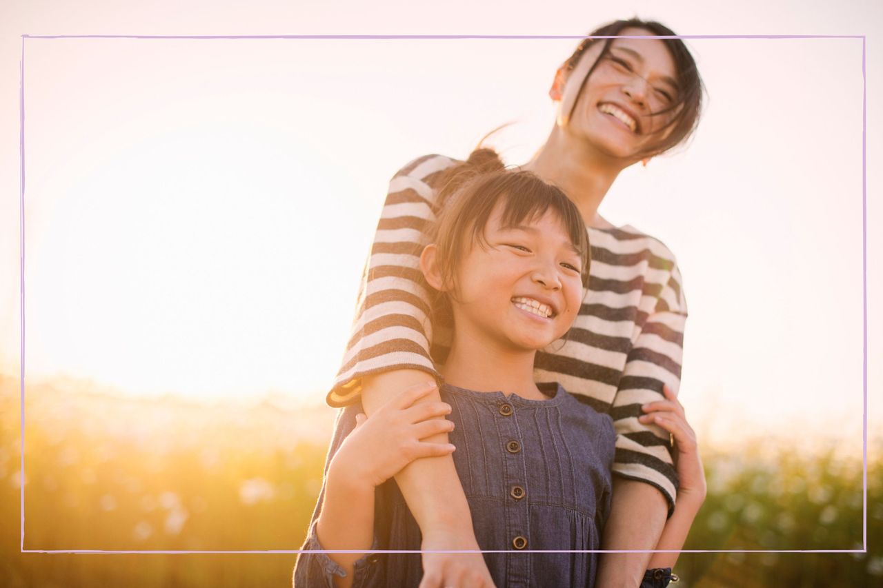 Happy mother and daughter smiling in the sunshine