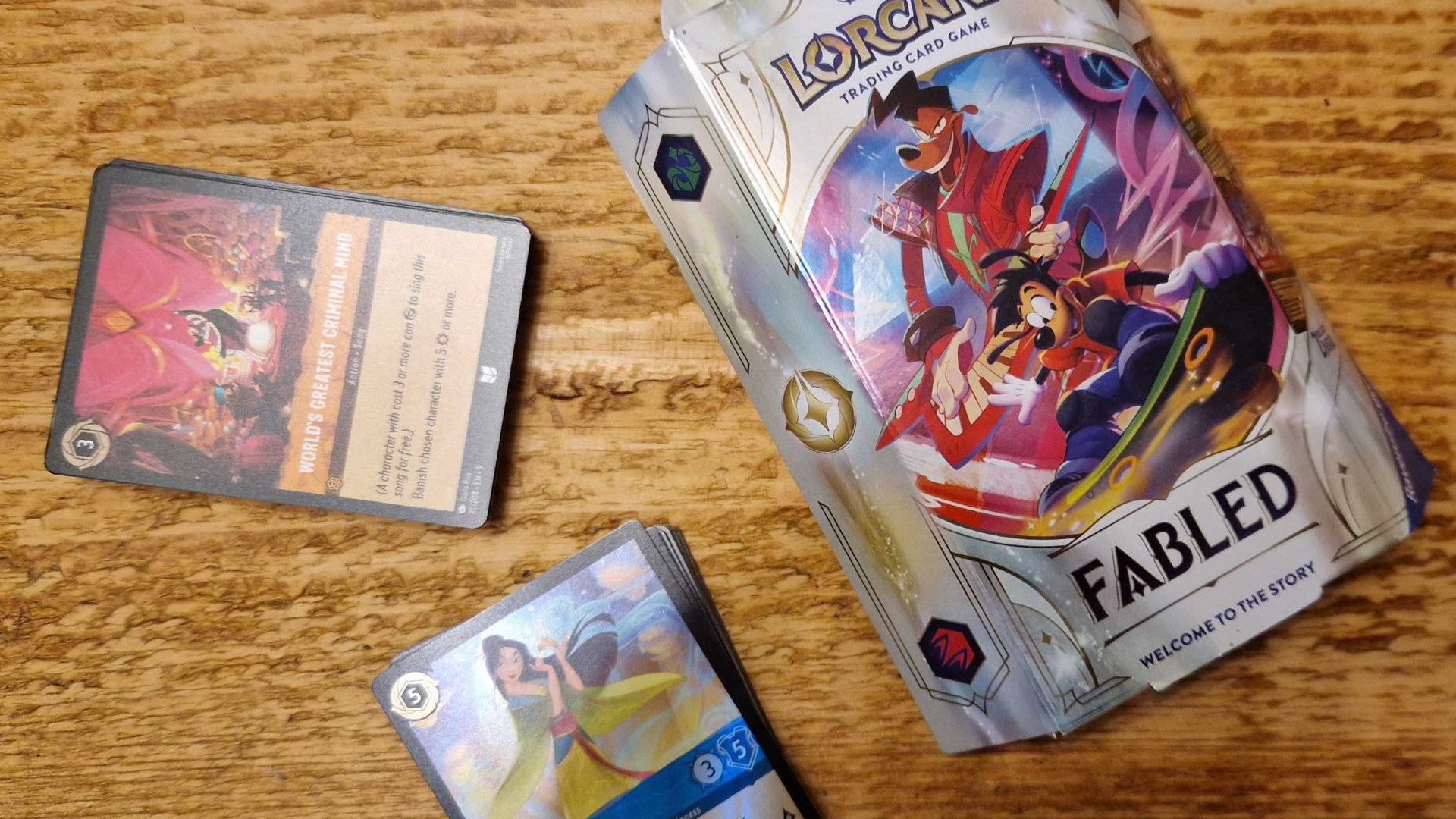 Disney Lorcana Fabled starter deck box and cards on a wooden surface