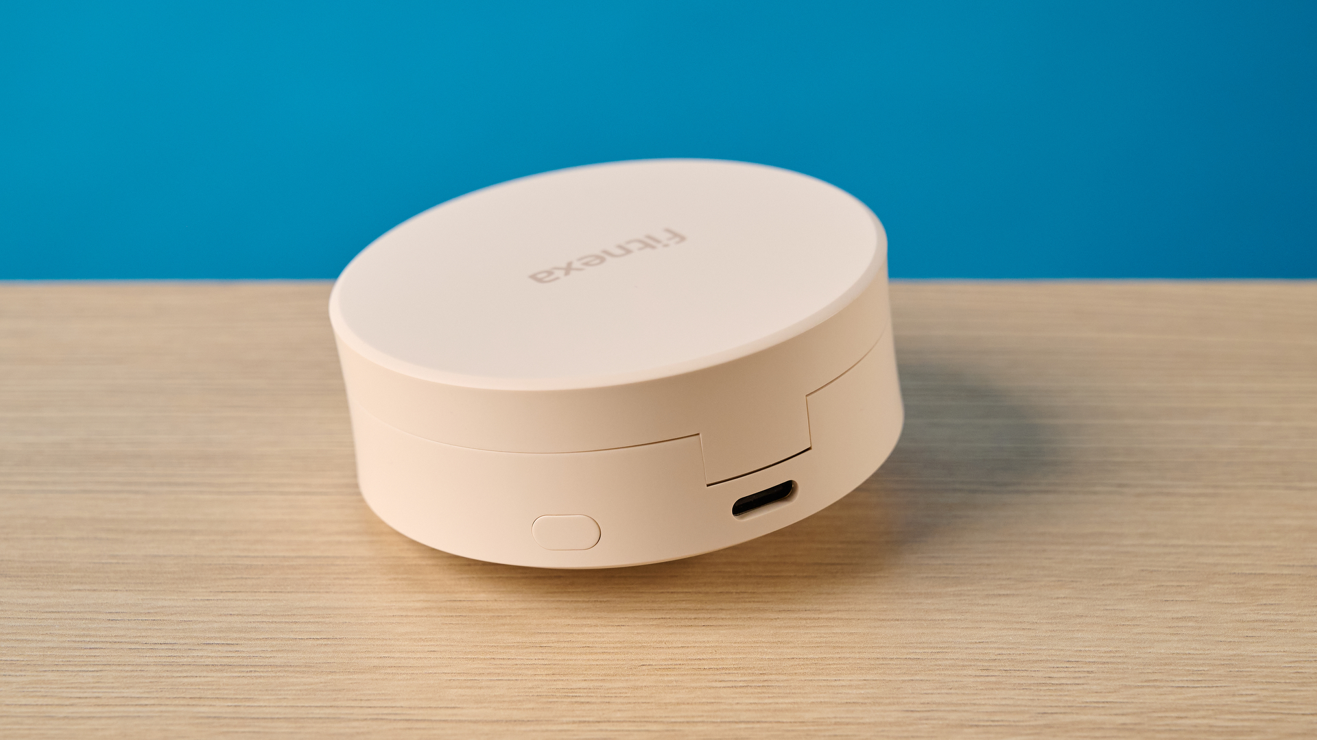 A closeup of the Fitnexa SomniPods 3 case showing the charging port at the back