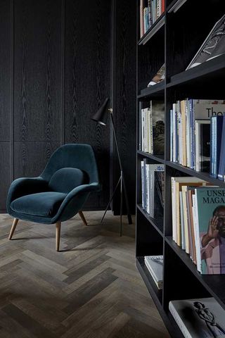 Mauritzhof Hotel room with green chair and black bookcase