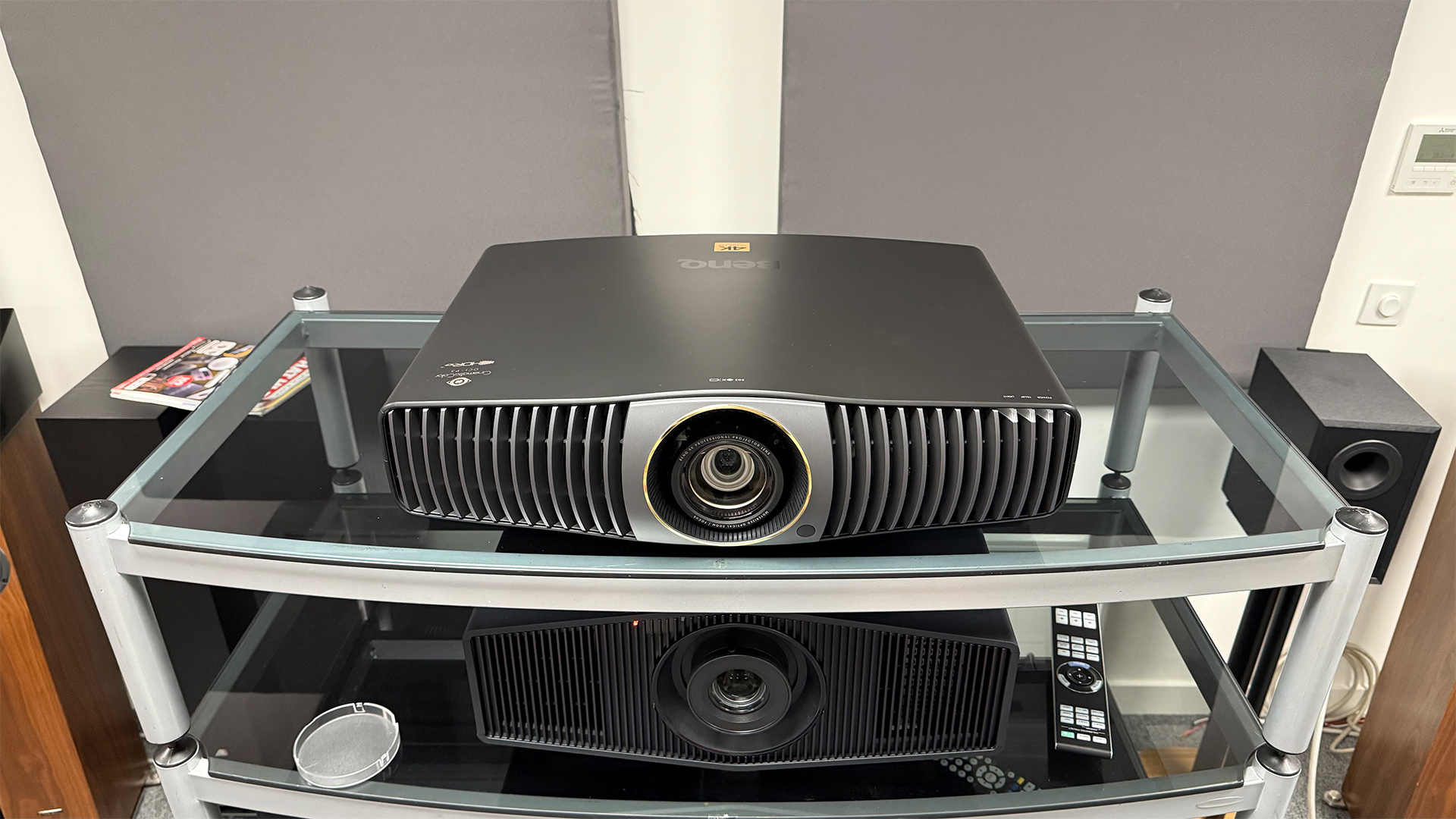 BenQ W5850 home cinema projector on glass AV rack above another projector