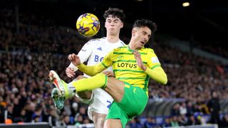 Archie Gray of Leeds United is challenged by Dimitris Giannoulis of Norwich City during the Sky Bet Championship match between Leeds vs Norwich