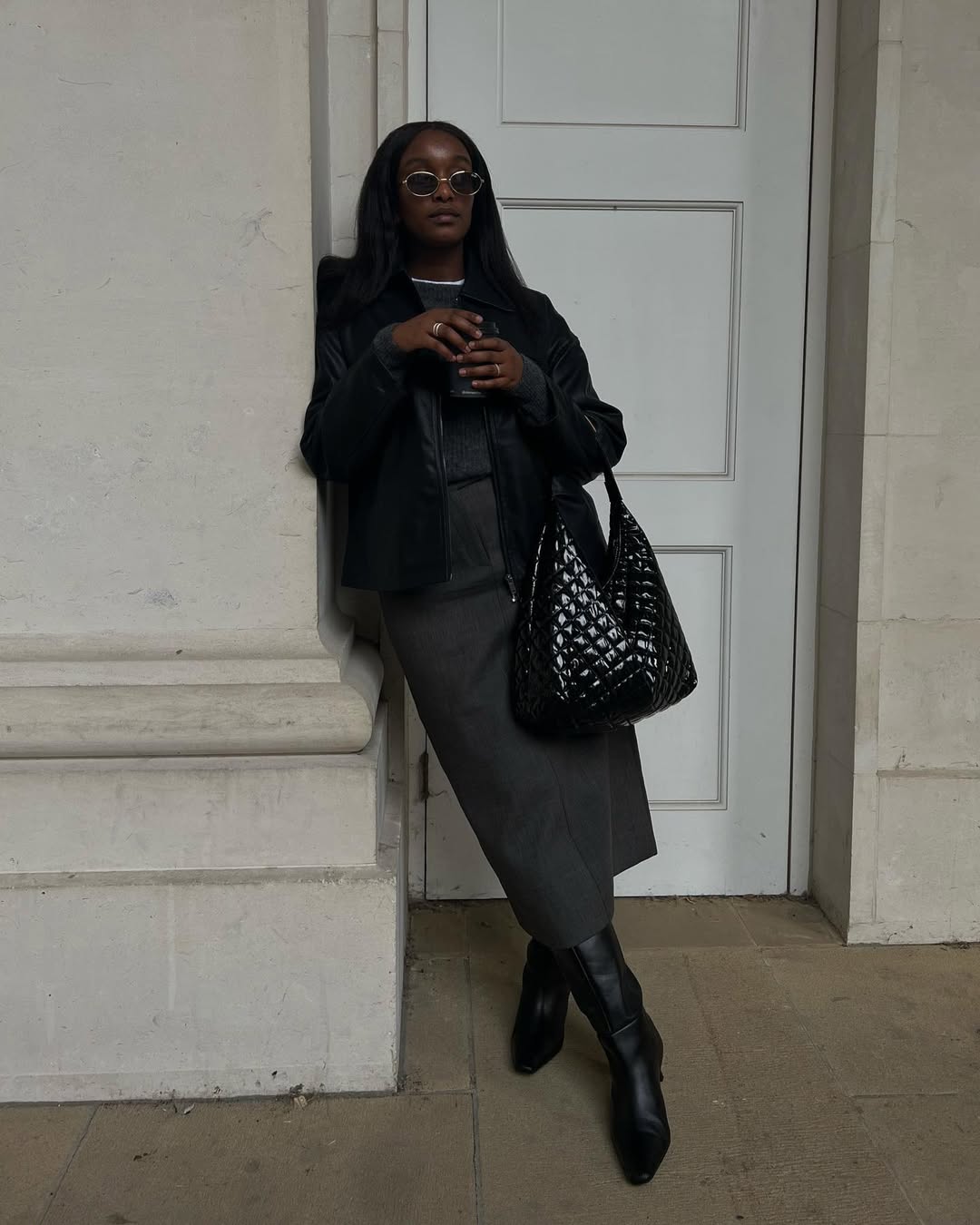Rebekah in a grey pencil skirt and boots