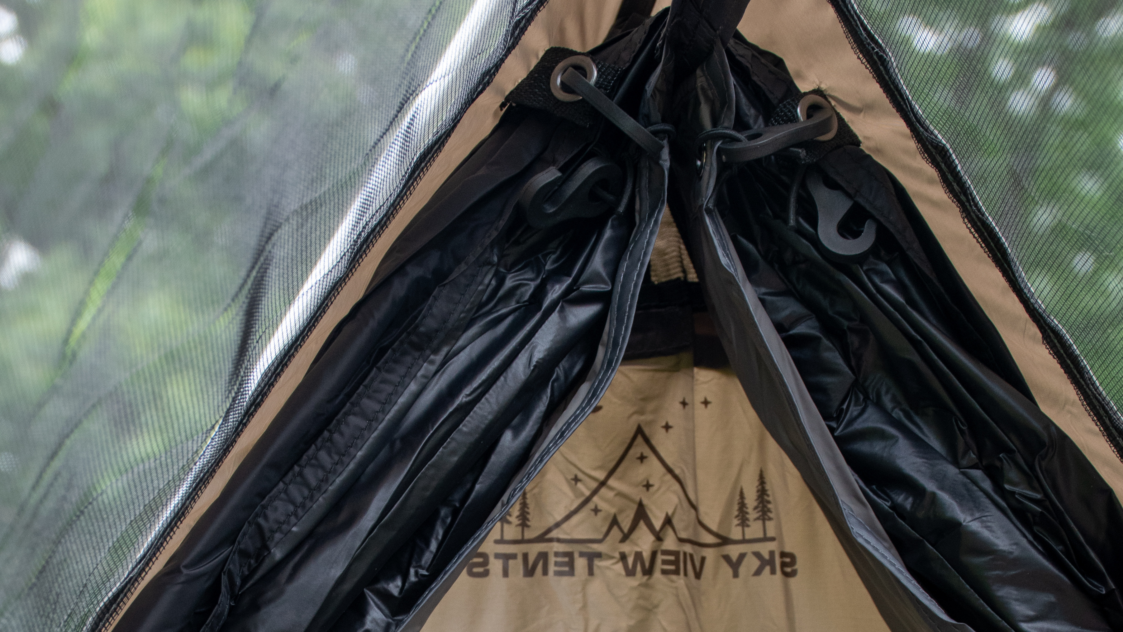 Nylon tent material is seen inside a tent.
