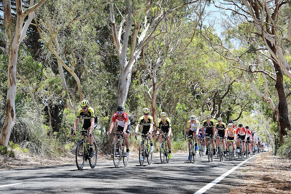 Riders compete through Willunga during stage three of the 2018 Tour Down Under