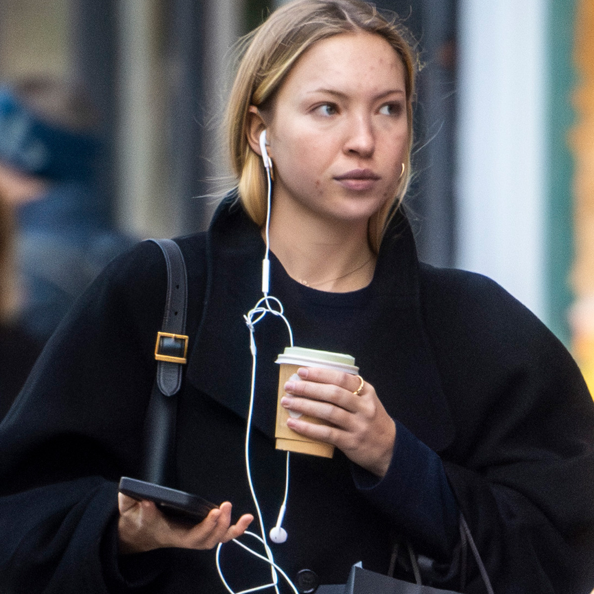 Lila Moss is seen doing some shopping in Notting Hill with a coffee. The English fashion model wore a long black coat over denim jeans and a Saint Laurent bag.