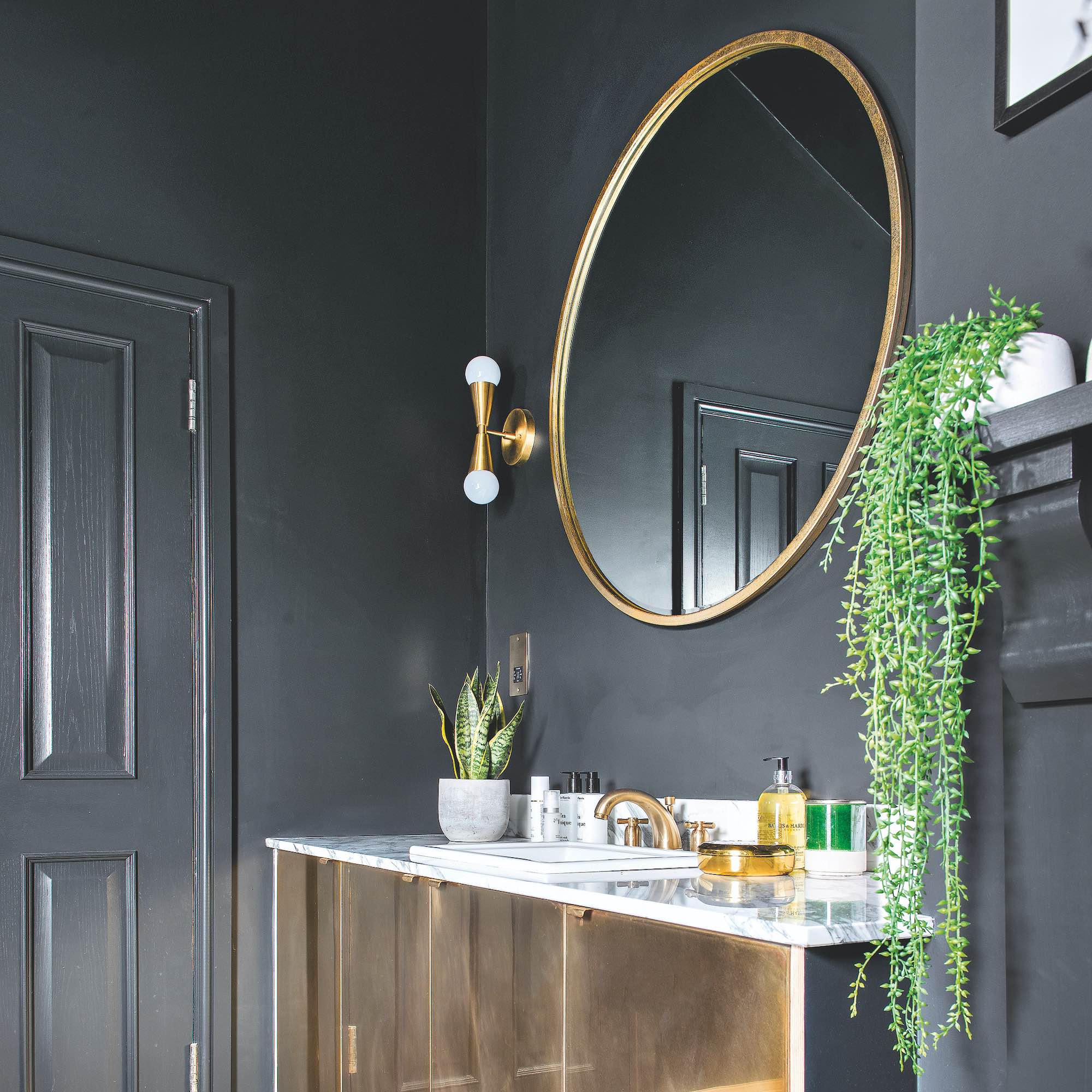 black painted bathroom with gold accessories