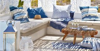 outdoor living room idea with a coastal theme by the sea