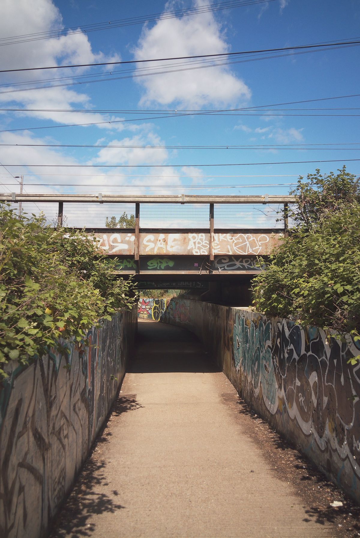 Photograph taken with the RewindPix digital compact showing an underpass and blue sky, with warm tones