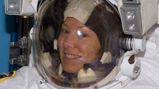 a close up of a human in a spacesuit, smiling