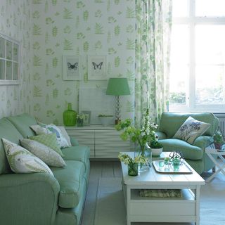 room with green sofa and white wooden flooring