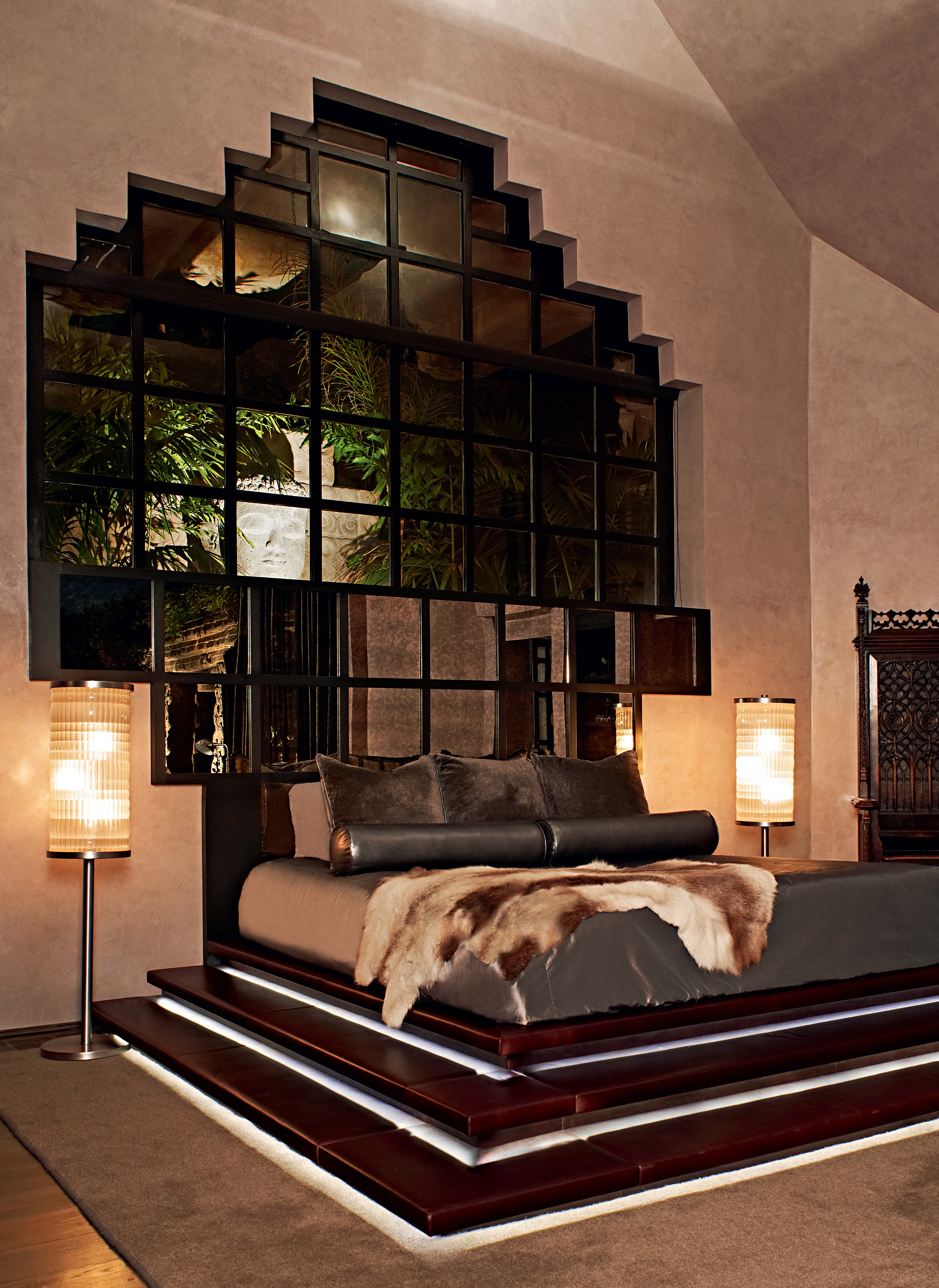 Bedroom with mirrored wall & fur blankets
