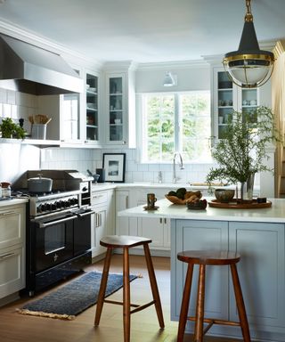 kitchen with white walls and cabinets and wooden stools