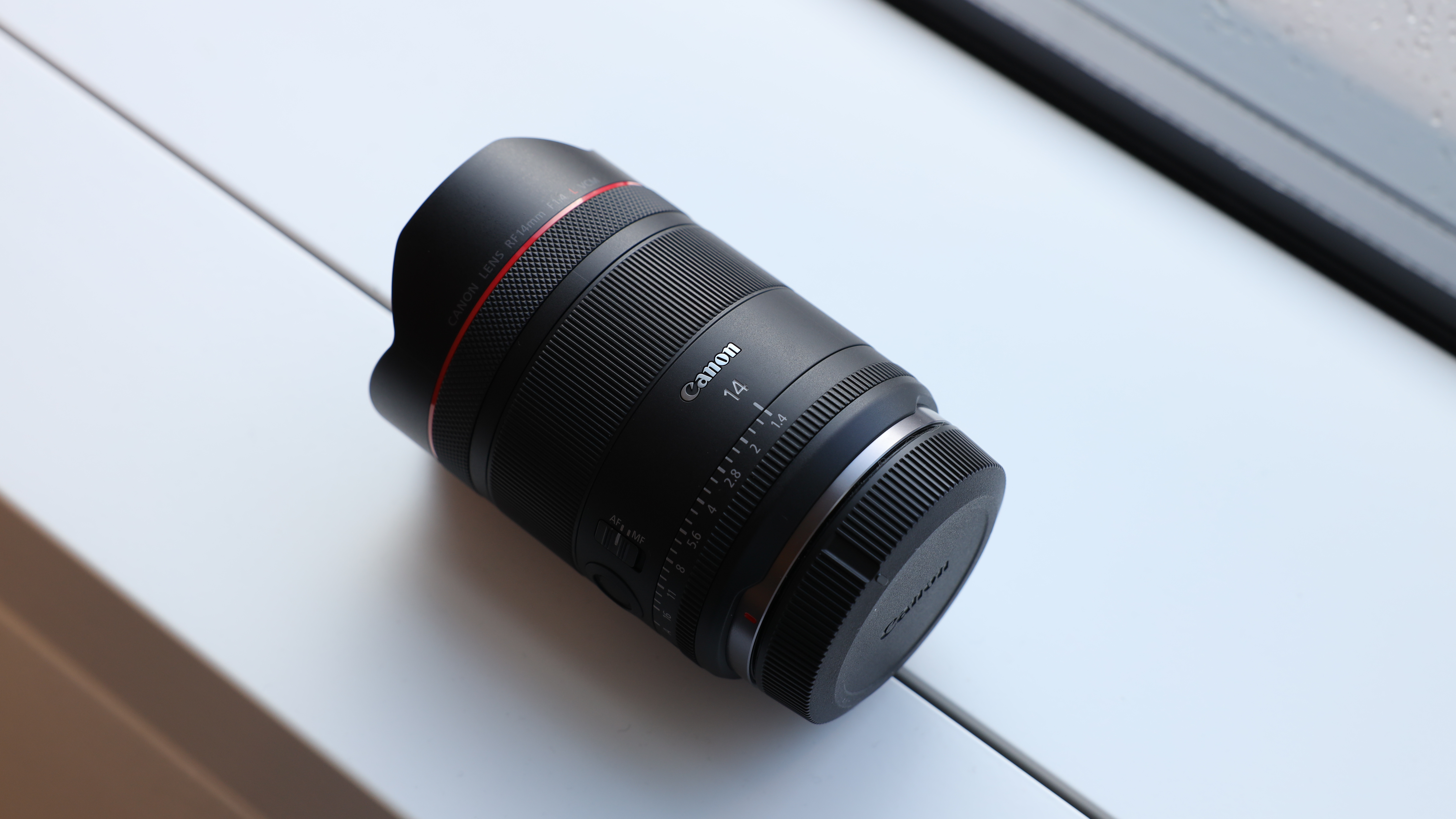 Canon RF 14mm f/1.4L VCM lens on a windowsill