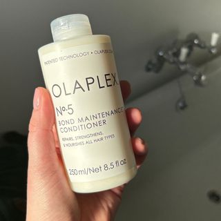 Laura holding Olaplex No.5 Bond Maintenance Conditioner - best hair conditioner