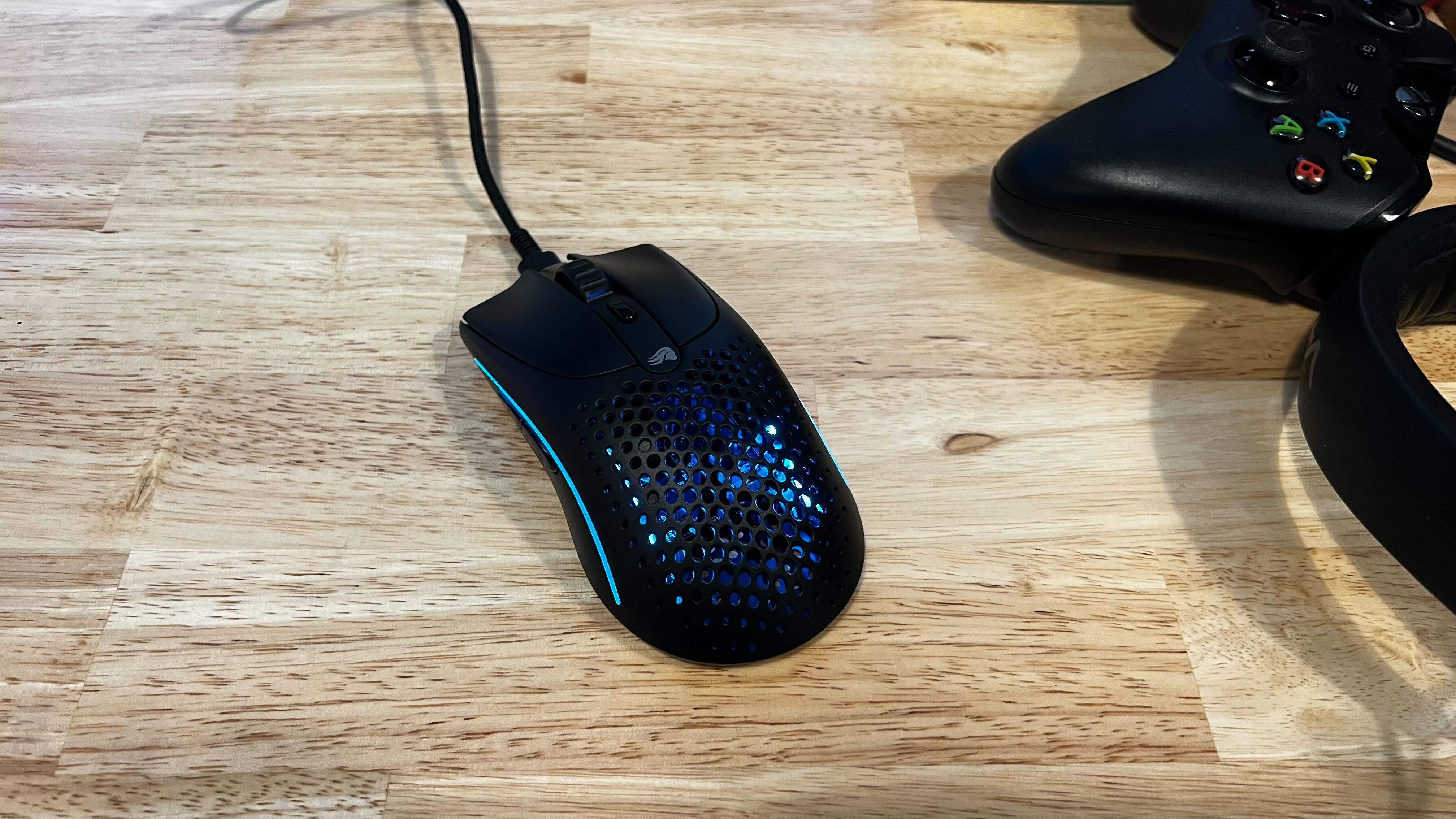 Glorious Model O2 wireless mouse on a desk.