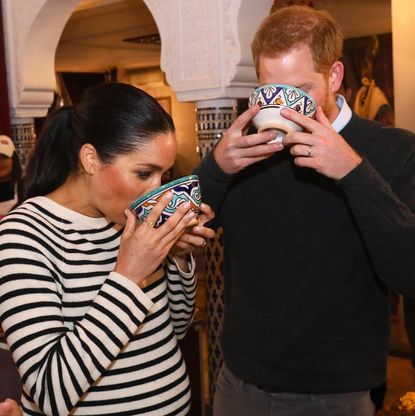 The Duke and Duchess of Sussex taking a sip 