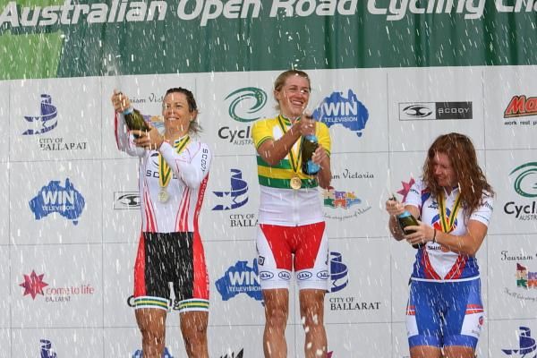 The medallists on the 2010 women's TT podium celebrate in traditional style. Bridie O'Donnell (VIC), Amber Halliday (SA) and Carly Light (SA)