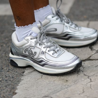 woman wearing chanel silver sneakers on the street 2024