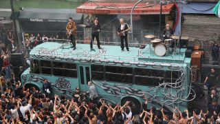 U2 filming their Street Of Dreams video on top of a bus in Mexico City