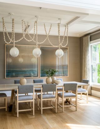 a dining room in a hamptons house with a rope light
