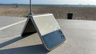 A Samsung Galaxy Z Flip 3 half folded, outside