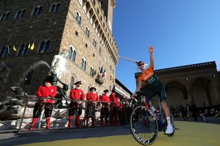 Team Jayco AlUla team's Australian rider Luke Durbridge cycles past the Palazzo Vecchio lined by onlookers dressed in historical costumes during the team presentation for the 111th edition of the Tour de France cycling race, in Florence in Italy, on June 27, 2024. (Photo by Thomas SAMSON / AFP)