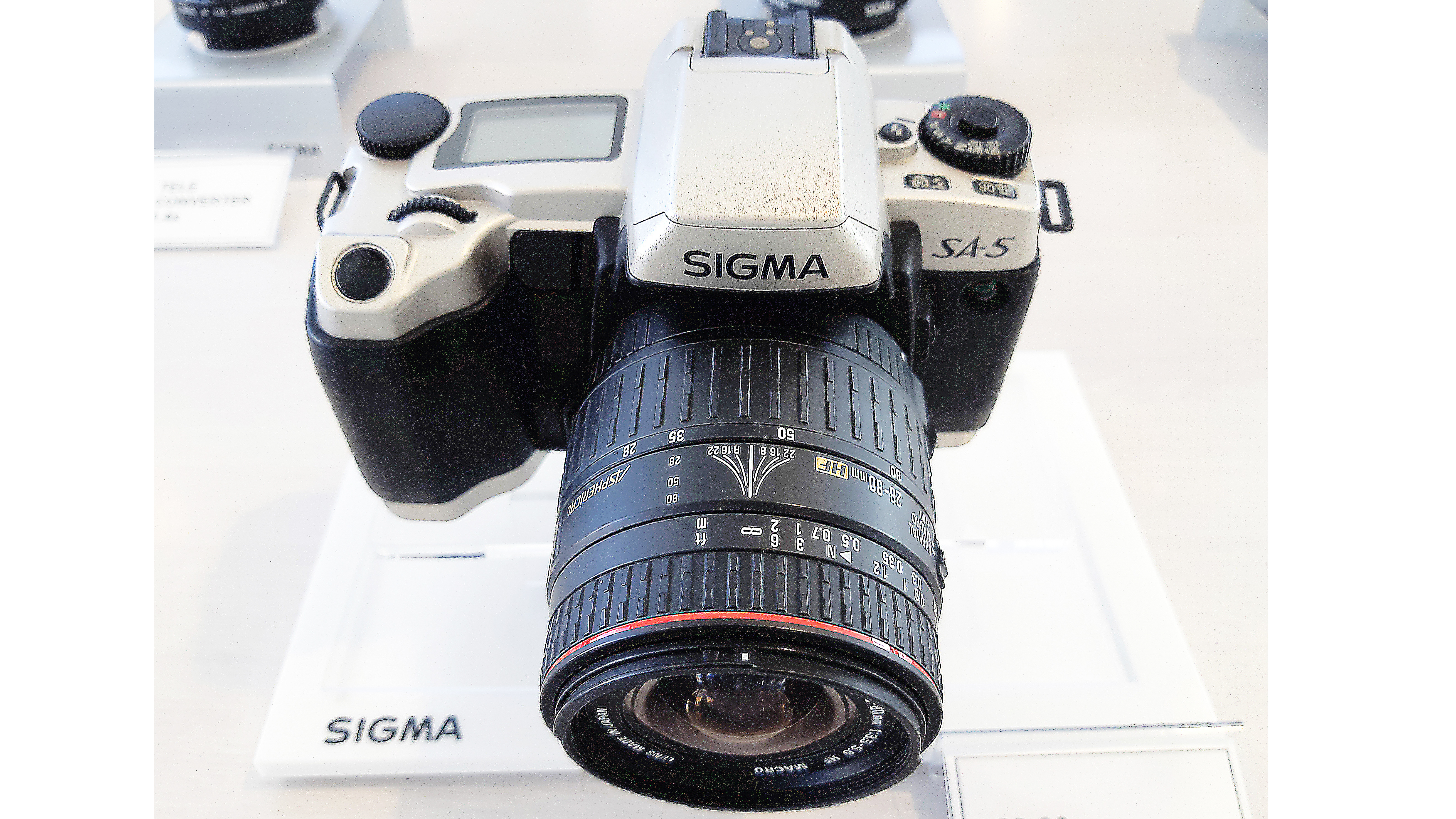 Sigma SA-5 (1997). The first autofocus Sigma 35mm SLR, with eight segment multi-zone metering, built-in pop-up flash and 3.0 fps continuous shooting.