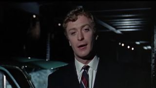Michael Caine wearing a suit talking to the camera in Alfie