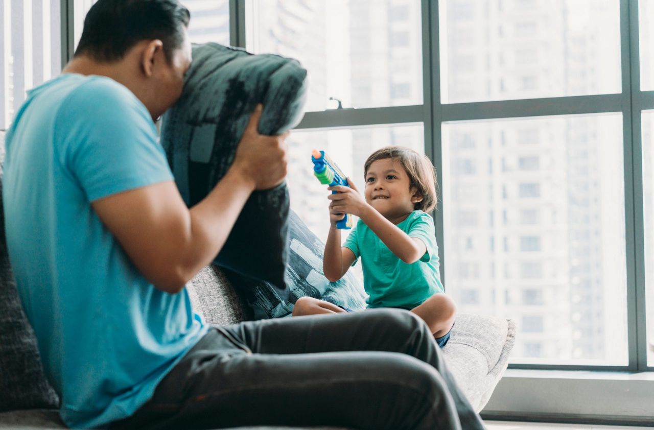 Boy playing with toy gun