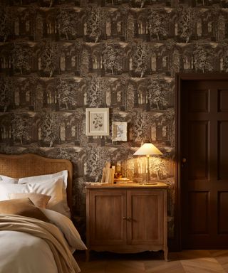 bedroom with brown illustrated wallpaper, wooden nightstand, woven headboard and cozy decor