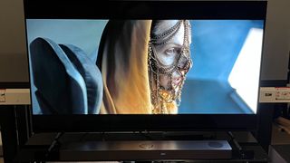 LG S80QY soundbar with TV image of woman