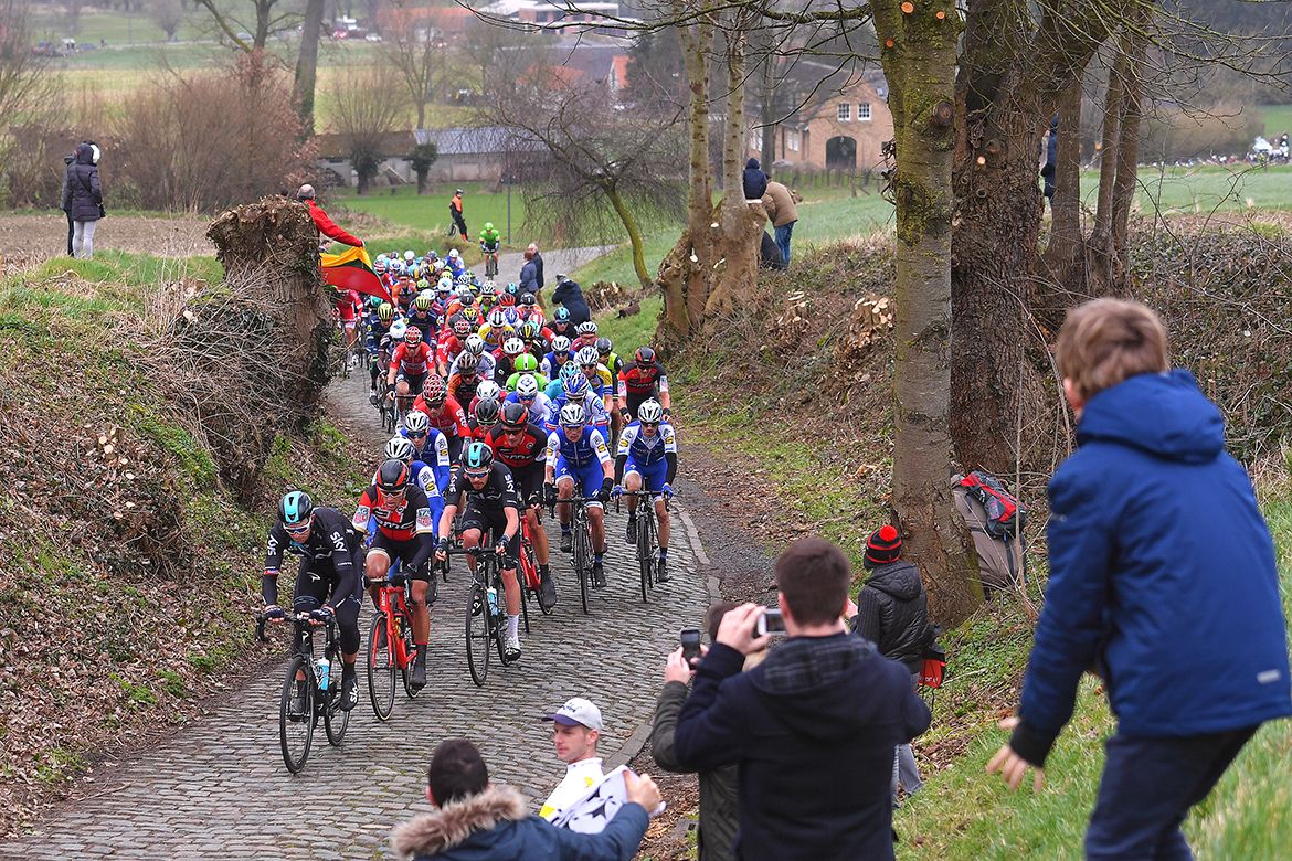 The Kuurne-Brussel-Kuurne peloton takes on one of the race's many cobbled sectors.