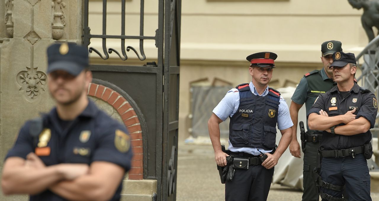 Security team known as Mossos d&amp;#039;Esquadra stand guard in Barcelona.