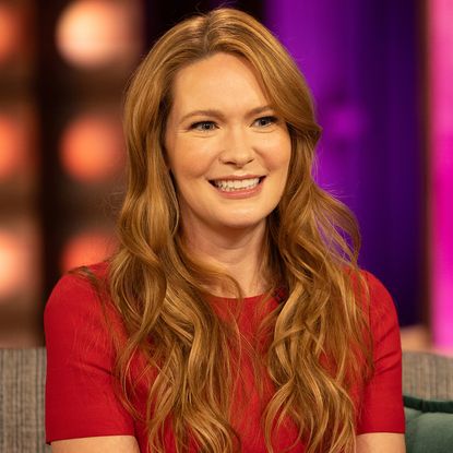 Sarah J. Maas wearing a red dress to tease the Call Her Daddy interview