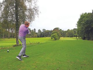 Keith Wood aiming down the left with his tee shot to hit a fade