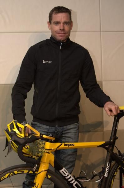 Cadel Evans poses for photos at a packed press conference
