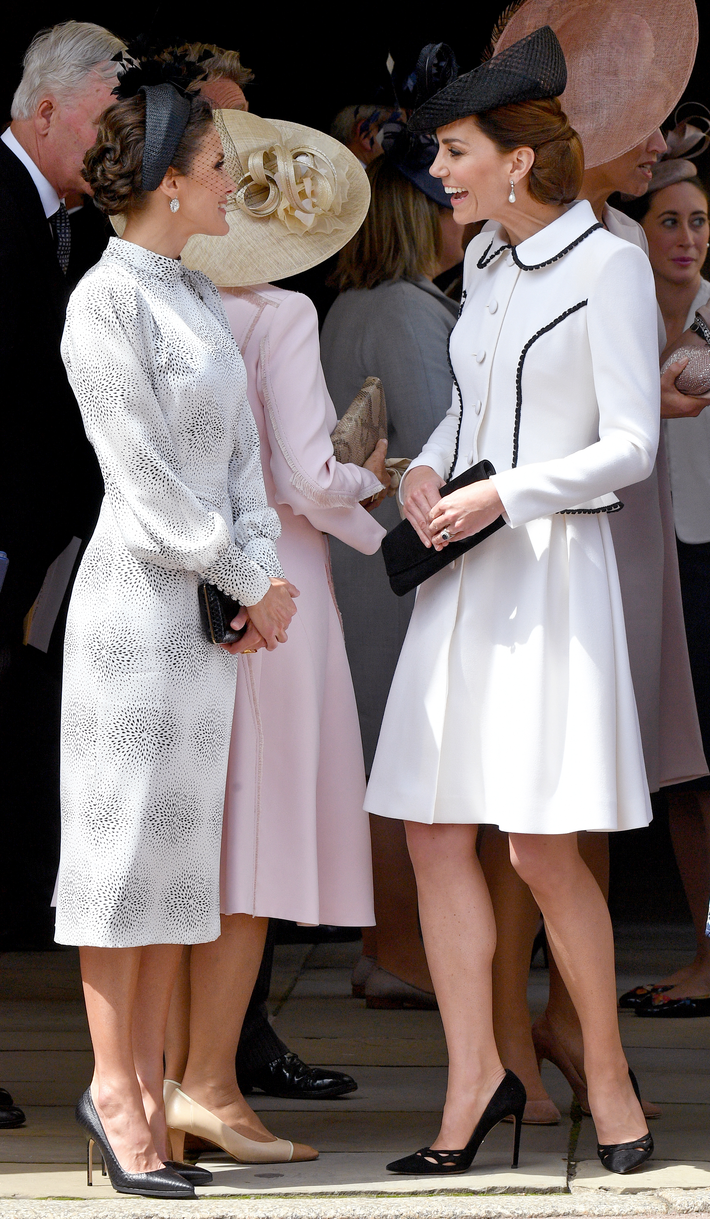 Princess Kate and Queen Letizia smiling at each other on Garter Day 2019