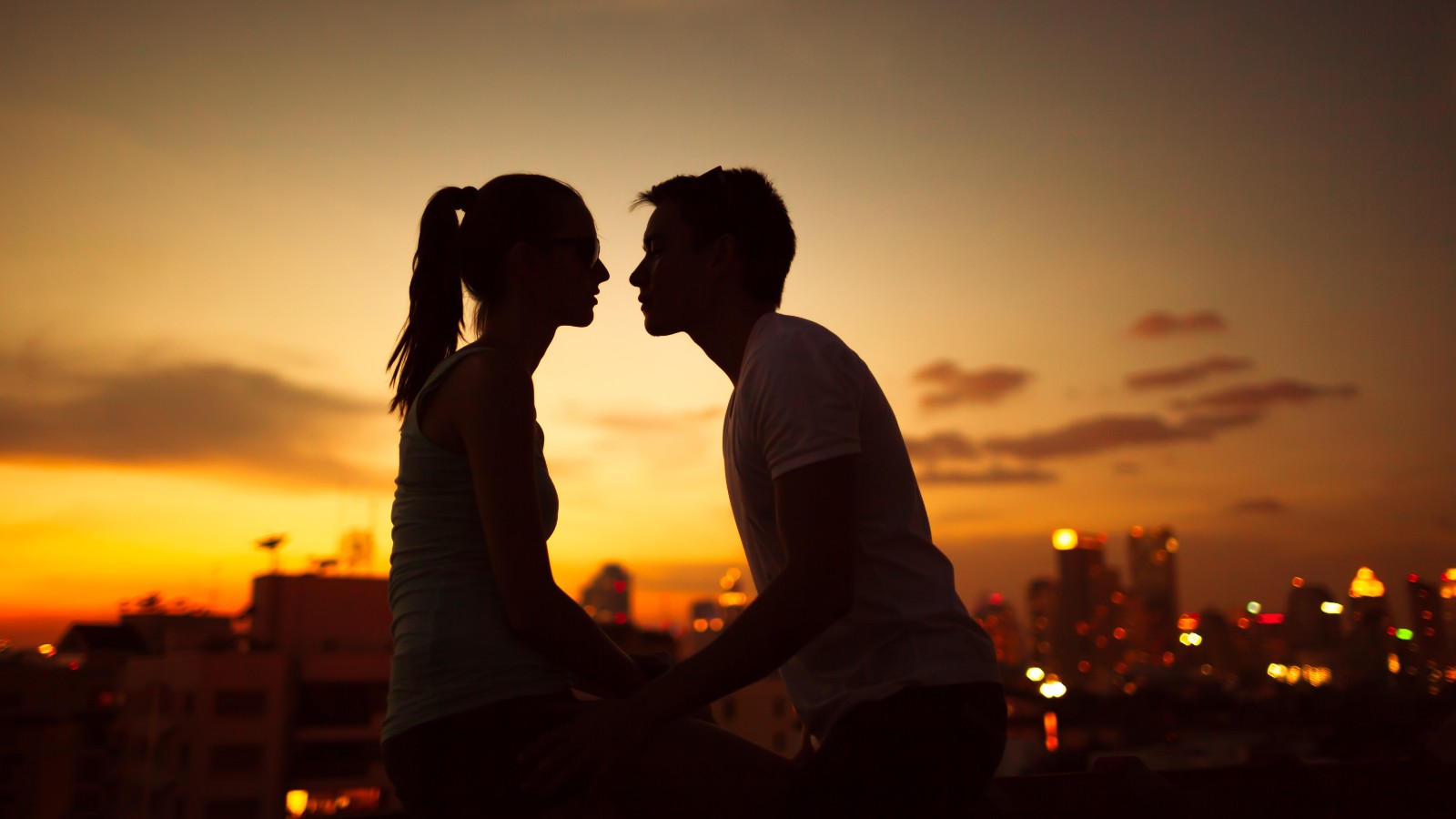 Couple kissing at night in the city