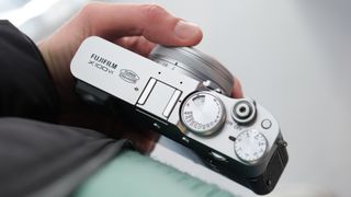 Fujifilm X100VI camera held in a hand